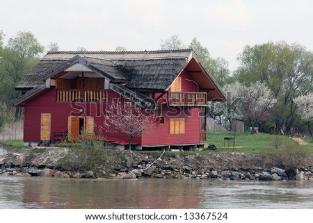 red holiday house on Danube river side