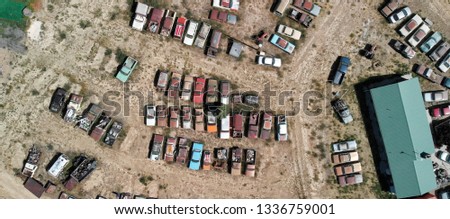 Overhead view of old cars gathered in a countryside parking.
