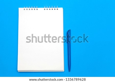 Blank white Notepad on blue background