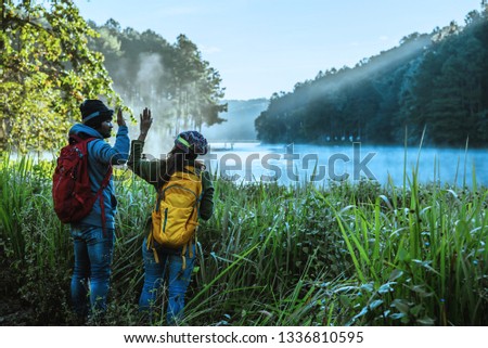 Couples asian Travel, take pictures of nature landscape the beautiful at Pang Ung lake, Thailand.