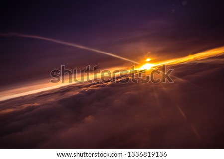 Amazing and beautiful sunset above the clouds with dramatic clouds