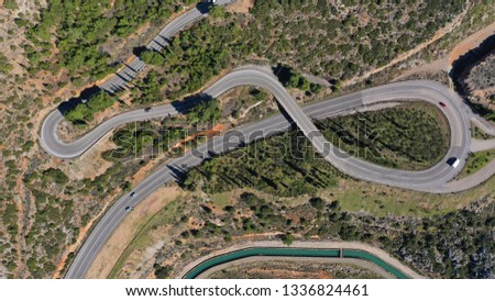 Aerial drone top view photo of serpent snake road on a steep mountain slope