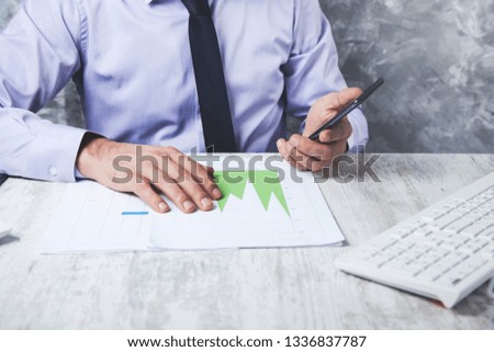 man hand phone with document on working desk