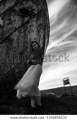 girl at the abandoned ship in white dress