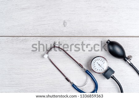 Medical stethoscope on gray wooden background