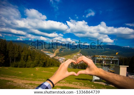 Europen lover couple woman and man travel nature. hand heart-shaped. With nature on summer mountain