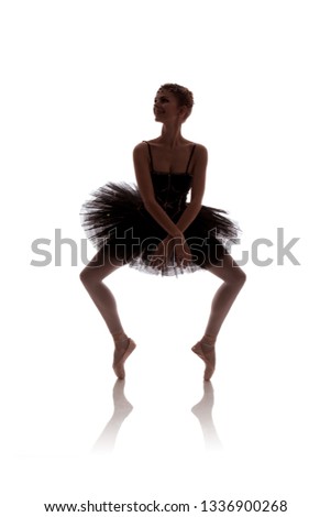 woman ballerina in black pack posing on white background
photo made in the style of "low key"