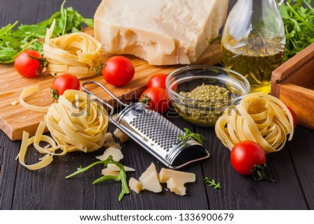set of raw pasta and addons on wooden table. Studio picture