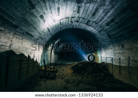 Scary underground tunnel or corridor in abandoned Soviet military bunker, industrial architecture with creepy atmosphere, toned