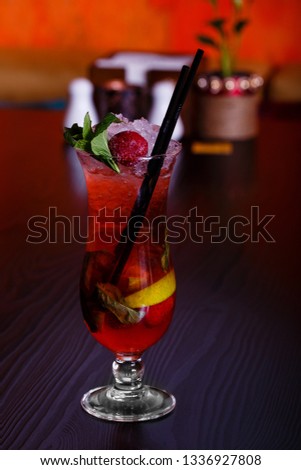 Cocktail with cola, ice, lemon, strawberry and mint