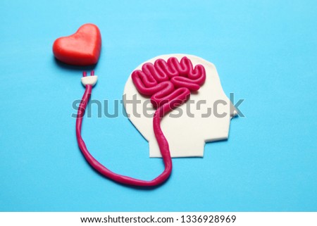 Figure of man with brain and red heart. Love and intelligence.