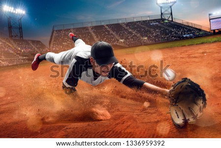 Baseball player at professional baseball stadium in evening during a game. Royalty-Free Stock Photo #1336959392
