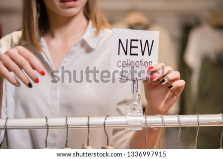 Woman with white sign with new collection words
