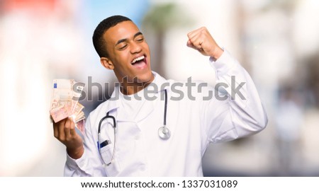 Young afro american man doctor taking a lot of money at outdoors