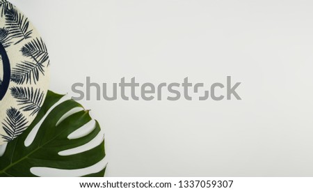 Flat lay, top view workspace with eye glasses, notebook, hat, pencil, green leaf, shoes and coffee cup on white background. Summer stylish traveller blogger concept.