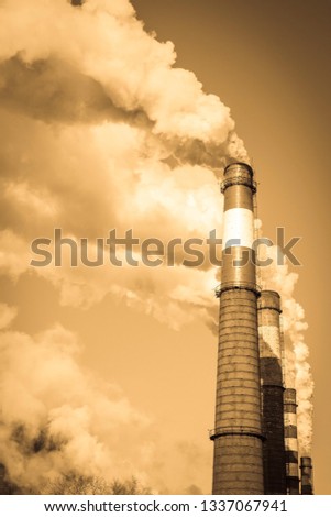 Plant, harmful production, air pollution. Large smoking chimneys against the sky. Toning, vignetting.