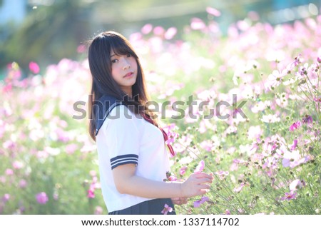 Portrait of Japanese school girl uniform smile with cosmos flower 