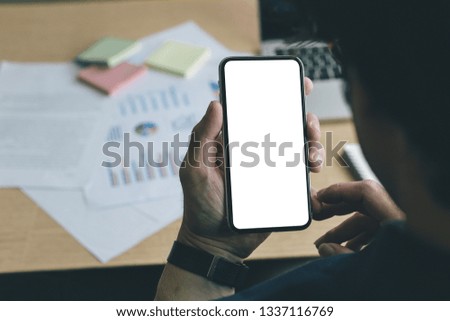 mockup image of cell phone.Businessman at workplace Think business investment plan.Contact Investor using cell phone,computer.make note of appointment information in the notebook.design creative work 