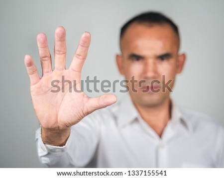 The man showing hand gesture stop sign isolated on white background.
