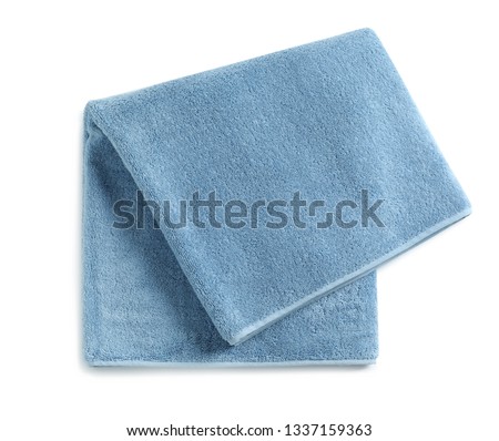 Soft folded towel isolated on white, top view Royalty-Free Stock Photo #1337159363