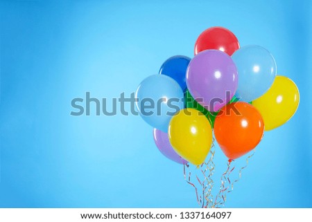 Bunch of bright balloons on color background. Space for text