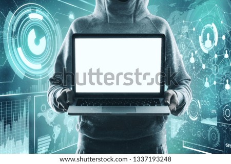 Hacker holding empty white laptop screen on glowing blue business interface background. Mock up 