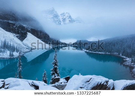 First snow Morning at Moraine Lake in Banff National Park Alberta Canada Snow-covered winter mountain lake in a winter atmosphere. Beautiful background photo concept