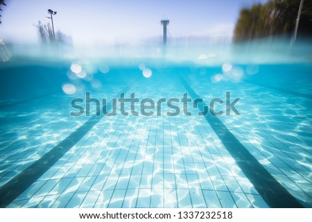 Wide angle underwater photo inside a swimming pool with racing lanes