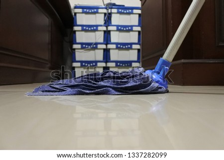 Blue mop on the floor.
