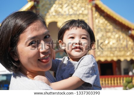 mom and son enjoy in temple