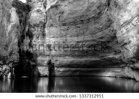 landscape view of streming water in the deseret canyon of Ein Ovdat nature reserve in the desere, Israel.