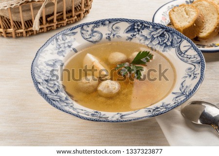 Dietary soup with chicken and egg on wooden table side view