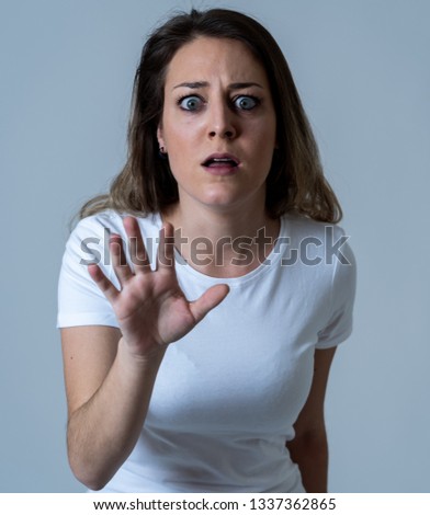 Close up of young woman feeling scared and shocked making fear, anxiety gestures. Looking terrified and desperate. People and Human expressions and emotions concept. Isolated on neutral background.