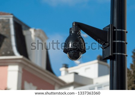 closeup of security camera on blurred urban background