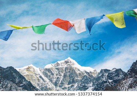 Everest trekking and hiking. Mountains of Nepal. Mountain in focus. Nepalese prayer flags are blurred. Adventure in the Himalayas Royalty-Free Stock Photo #1337374154