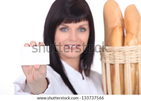 Female baker showing businesscard