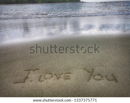 I Love You written on the beach.