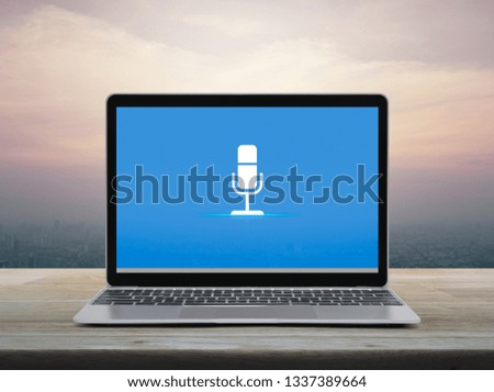 Microphone flat icon with modern laptop computer on wooden table over office city tower and skyscraper at sunset sky, vintage style, Business communication online concept