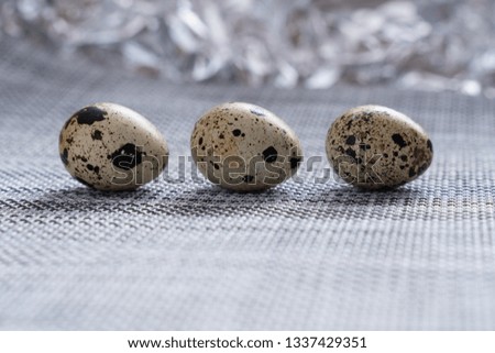 quail eggs on grey fabric table and beautiful blurred background close-up