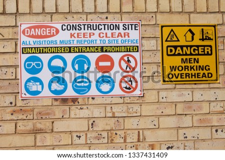 PPE signage on brick wall