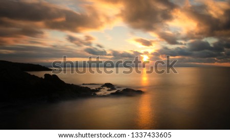 SUNSET, SEA, CLOUDS AND LONG SHUTTER Royalty-Free Stock Photo #1337433605