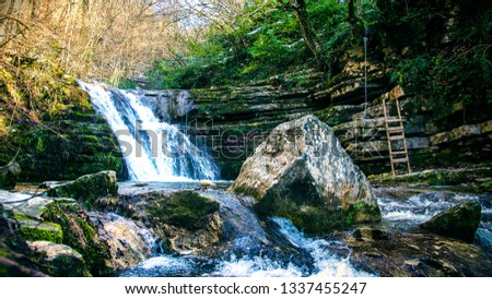 waterfall in the forest Royalty-Free Stock Photo #1337455247