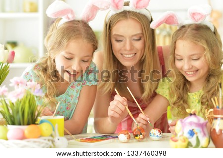 Portrait of mother with her daughters preparing for Easter