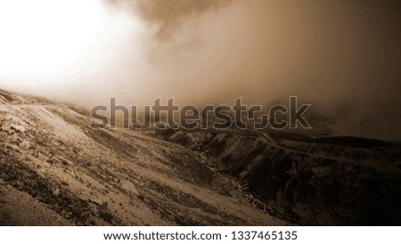 mountain top clouds and rocks Royalty-Free Stock Photo #1337465135