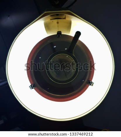 Rear view of  electronics magnifier with lights on and the secondary lens on its center
