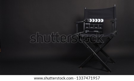 Clapper board or movie slate with director chair use in video production or movie and cinema industry. It's black color. Royalty-Free Stock Photo #1337471957
