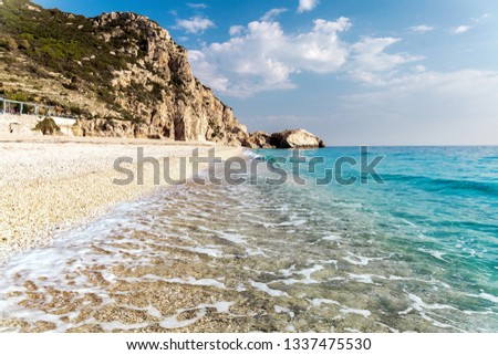 Awesome Sunny seascape. Beach and waves and perfect sky. Summer view of Kathisma Beach. Wonderful nature scene of Lefkada Island, Greece. Adventures and exotic travel concept. flip image