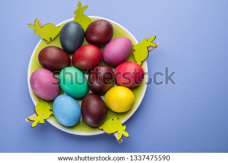Colorful Easter eggs as an attribute of Easter celebration. Pink background.
