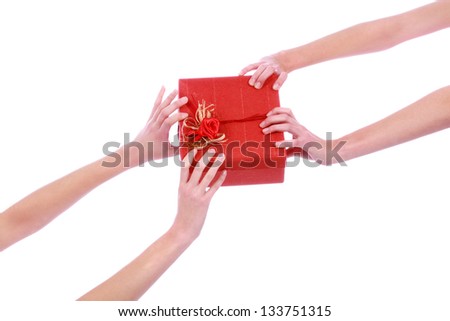 closeup picture of two woman's hands with red gift box over white background