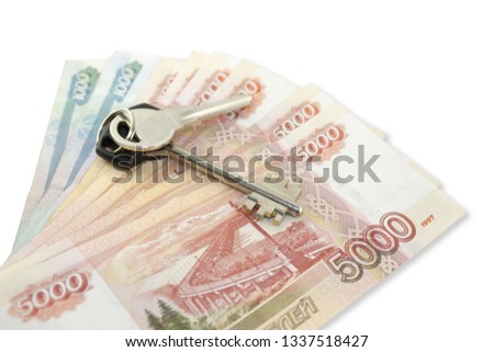 Metal keys of a variety of banknotes of five and one thousand Russian rubles. Concept of buying an apartment, flat or house, mortgage, rental housing, housewarming, home expense
